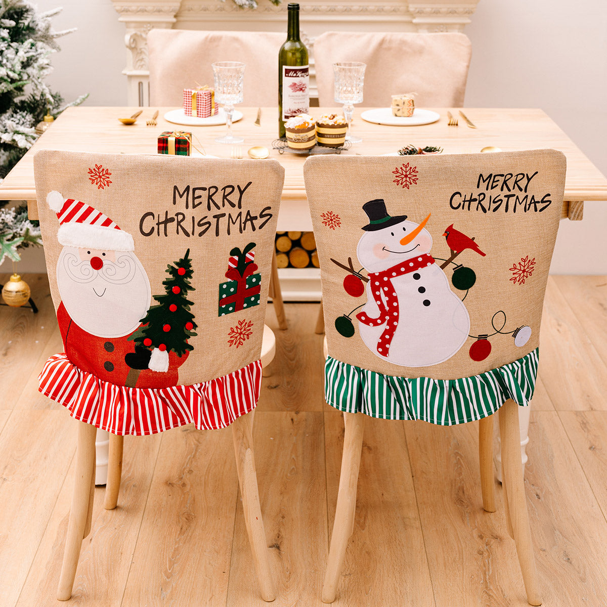 Two Christmas-themed chair covers with Santa Claus and a snowman on a dining table.
