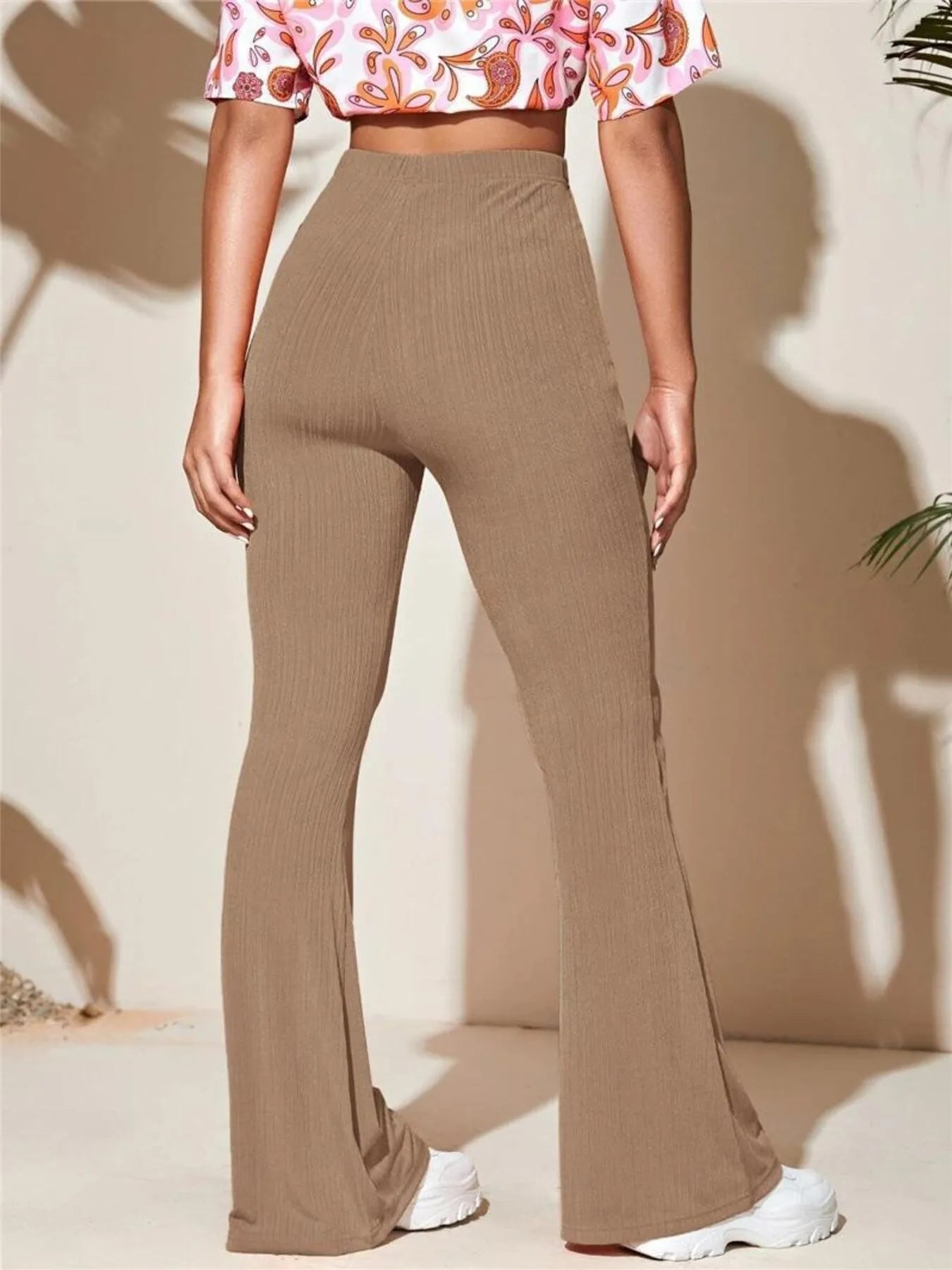 Model wearing high waist flared pant suit in sleek polyester fabric, styled for confident movement and tailored elegance — part of Dias Dazzling Discoveries’ Beyond the Tag collection.