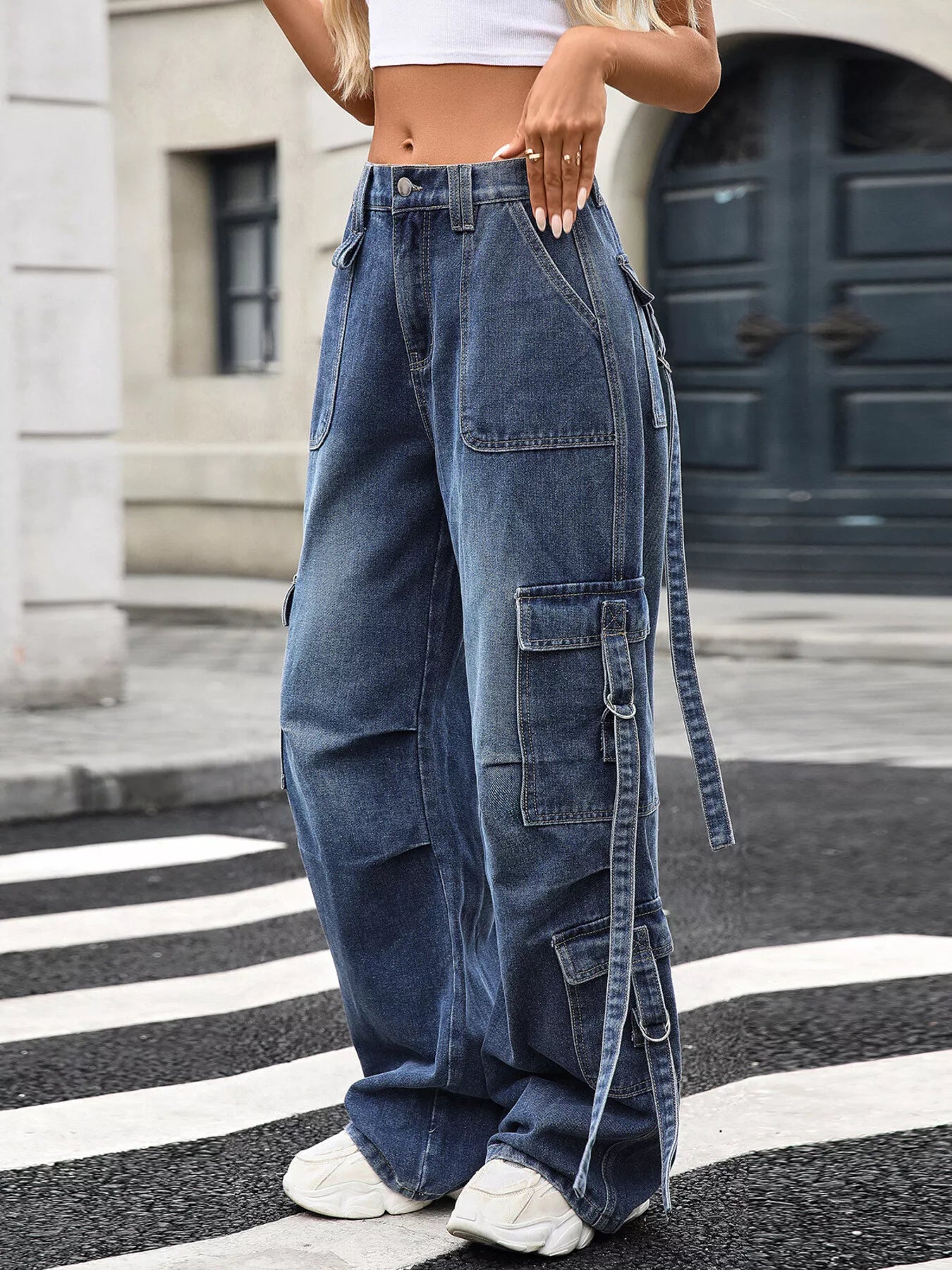Person wearing blue cargo pants on a city street