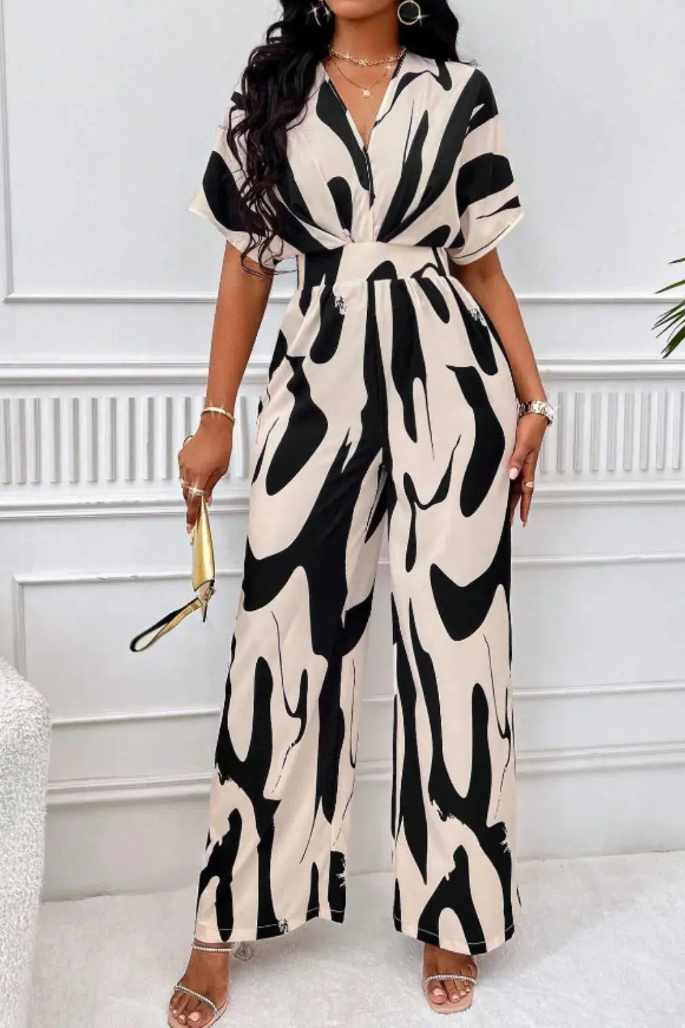 “Women’s V-neck short sleeve wide-leg jumpsuit in opaque polyester, available in US sizes 4 to 16”