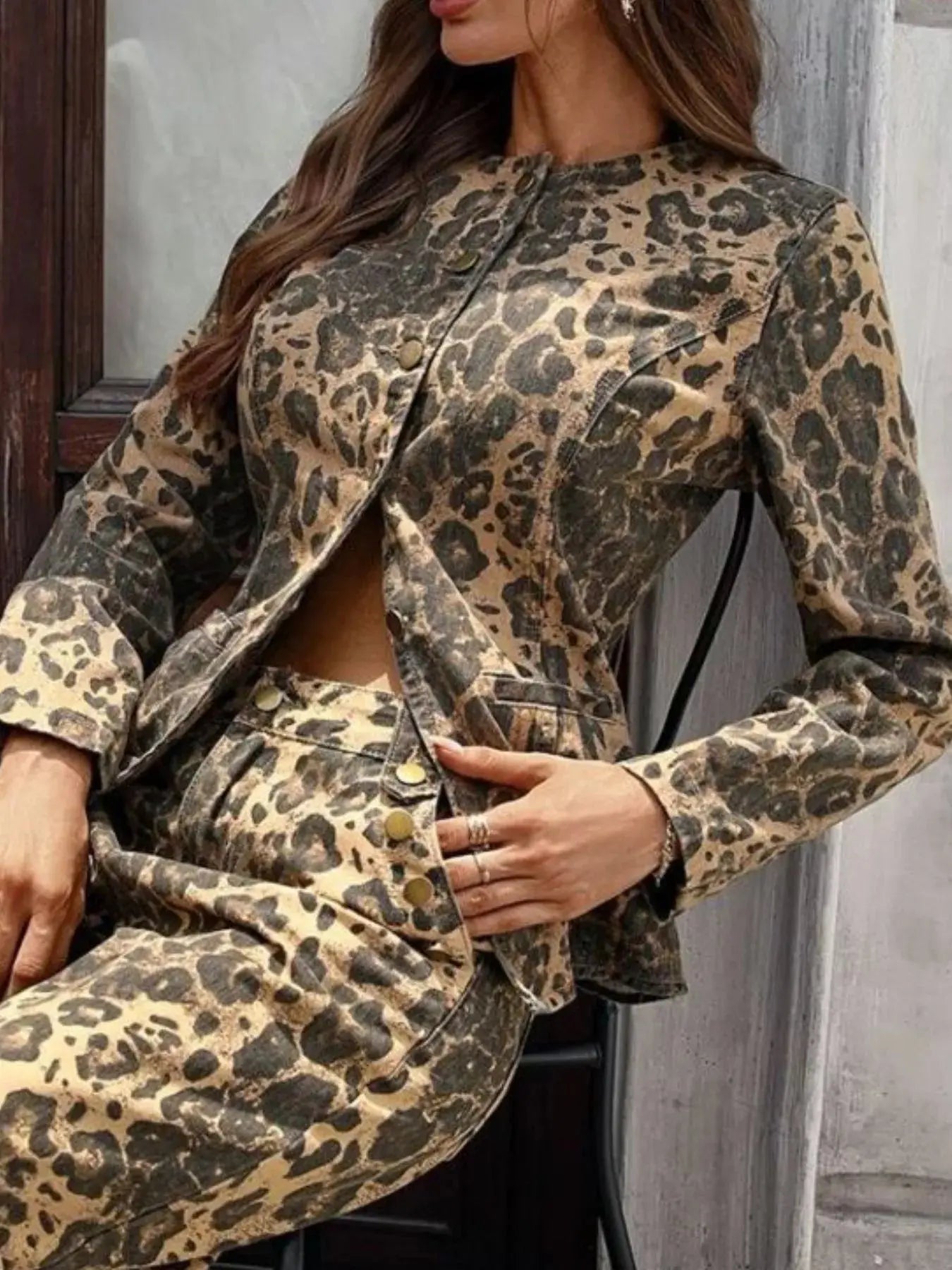 Person wearing a leopard print outfit against a neutral background